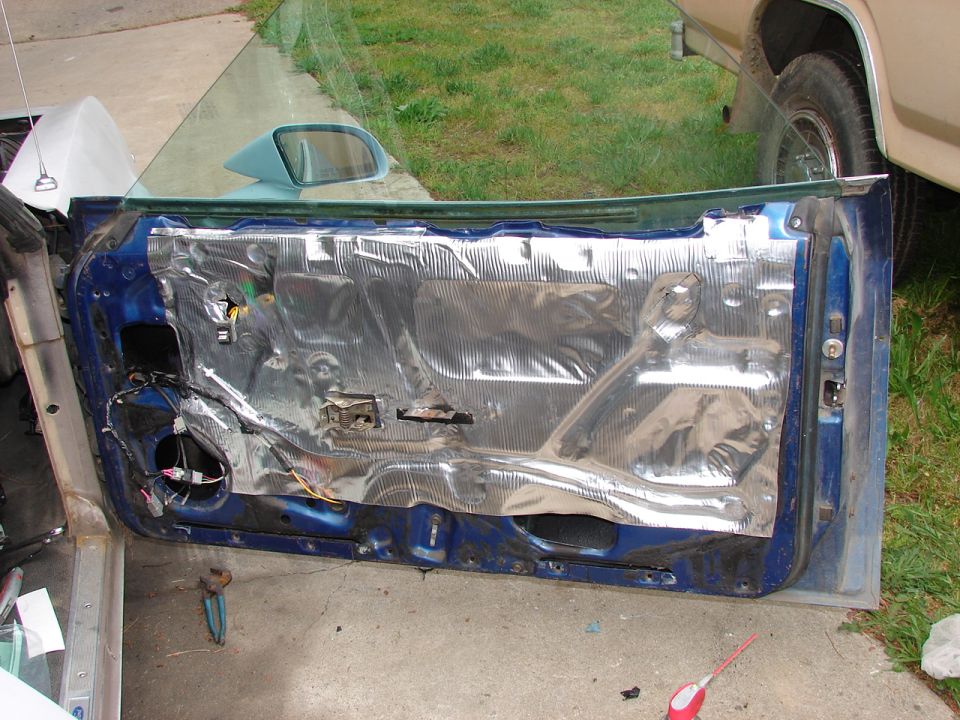 Blue car door interior with sound deadening material installed