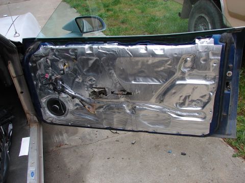 1973 Ford Ranchero - Car door interior with sound deadening material and speaker wiring exposed.