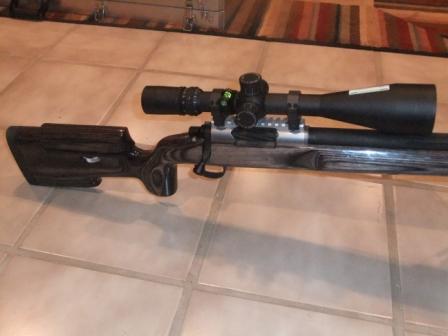 1996 Ford Bronco - A sniper rifle with a scope and a custom wooden stock is shown on a tiled floor.