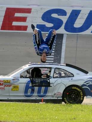 2007 Ford Mustang - A race car driver performs a flip on the roof of a race car during a competition.