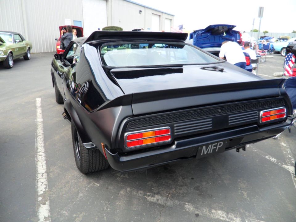 Black coupe with a spoiler and custom taillights, rear view. License plate reads MFP