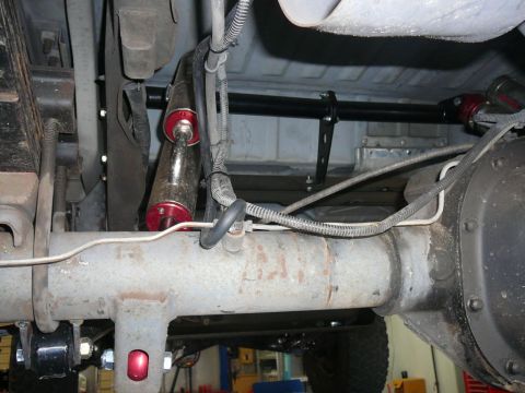1988 Ford Bronco - Close-up view of the rear axle and suspension components of a vehicle.