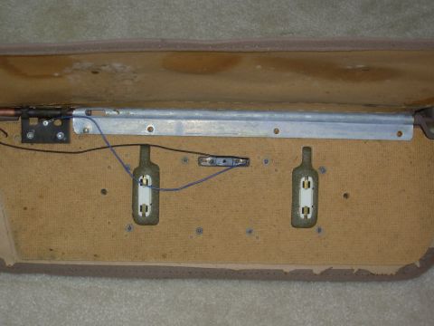 1983 Ford Bronco - After ripping the sewn seam, the upholstery can be unfolded to expose the back of the vanity assembly. Note the 8 small stamped nuts screwe…
