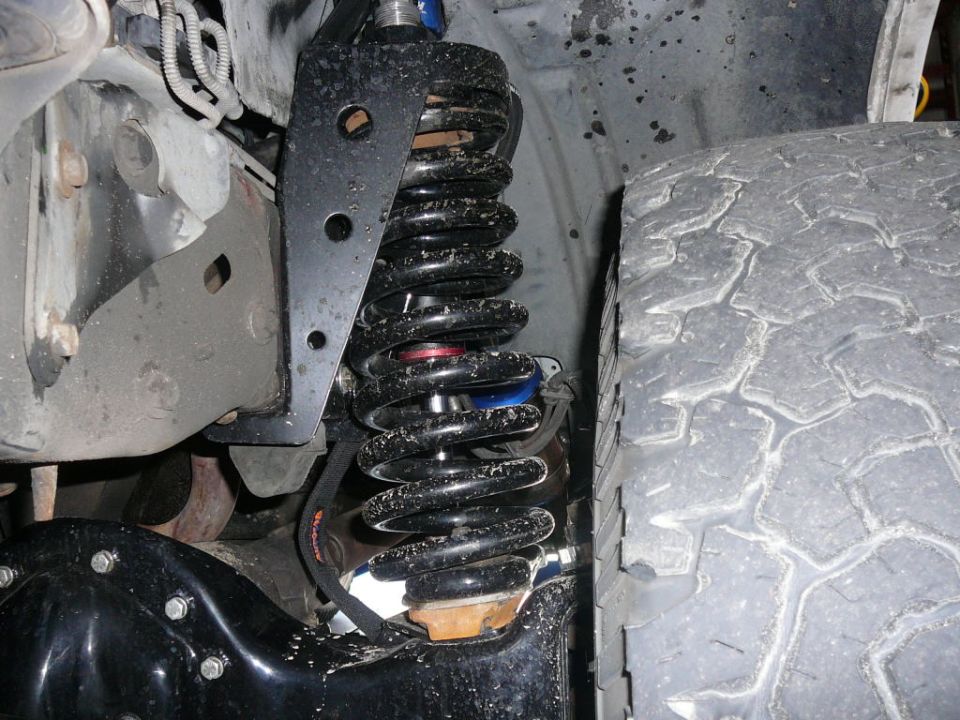 Black coilover shock absorber and tire tread
