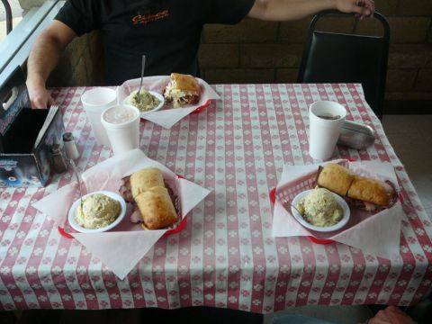 1988 Ford Bronco - Table set with three meals, drinks, and condiments at a restaurant.