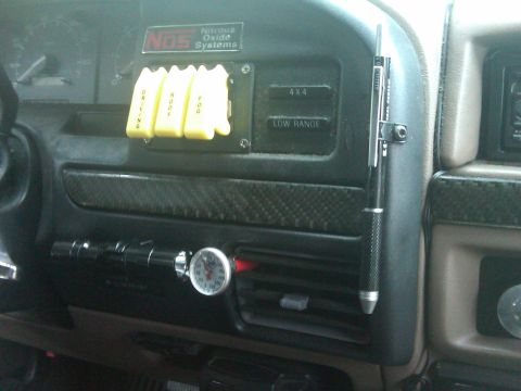 1993 Ford Bronco - Interior dashboard view showing aftermarket NOS system and 4x4 controls.