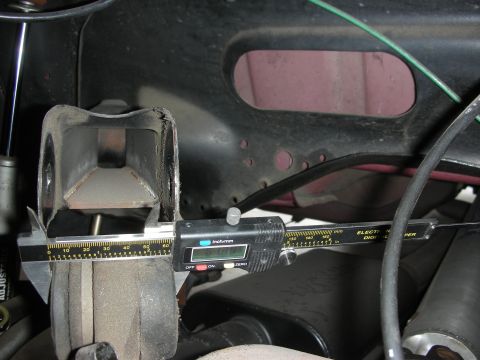 1998 Ford Crown Victoria - Measuring suspension part with digital calipers, reading 0.99 inches.