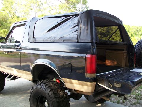 1990 Ford Bronco - Rear view of a 1990 Ford Bronco, a soft top and open tailgate.