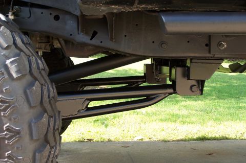 2000 Ford F-150 - Undercarriage view of truck suspension components and a large tire.