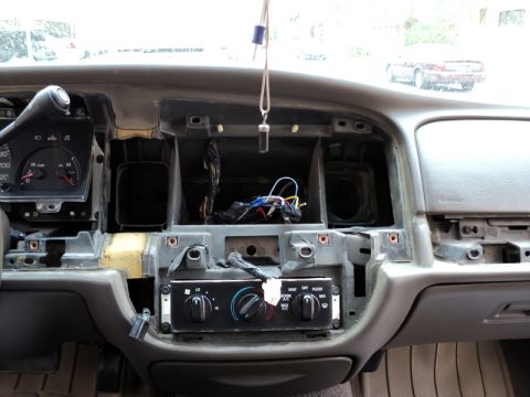 2001 Mercury Grand Marquis - The interior of a 2001 Mercury Grand Marquis shows a disassembled dashboard with exposed wiring and climate controls.