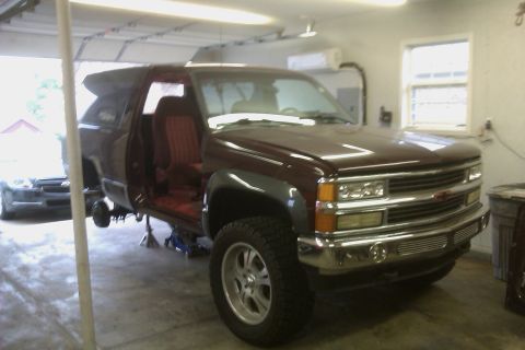 1994 Chevrolet Blazer - This SUV is in a garage, lifted on jack stands with its doors open, revealing the interior.