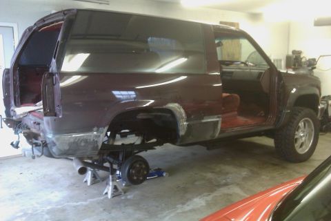 1994 Chevrolet Blazer - This 1994 Chevrolet Blazer is undergoing repairs, with its rear end removed and the vehicle supported by jack stands.
