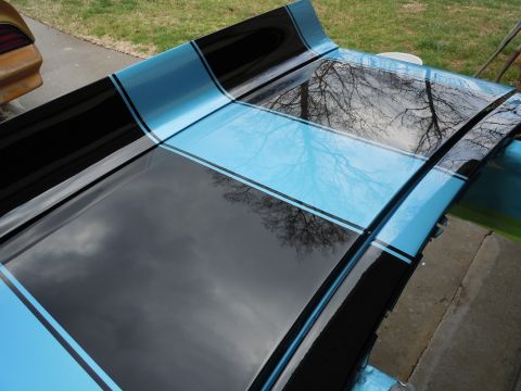 1972 Chevrolet Camaro - Car hood with racing stripes. Another vehicle is partially visible on the left.