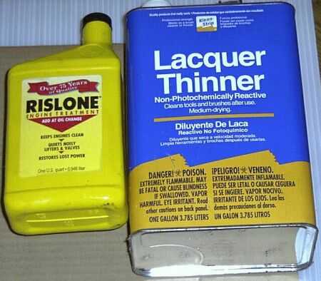 1997 Ford Taurus - A bottle of Rislone Engine Treatment sits next to a can of Lacquer Thinner.