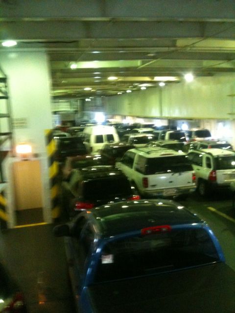1993 Ford Bronco - A ferry is packed with vehicles, including cars, vans, and SUVs, all parked in rows.