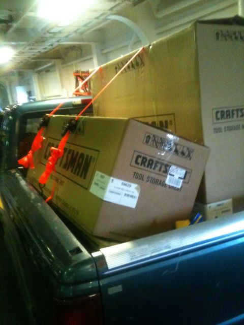1993 Ford Bronco - Pickup truck bed filled with secured tool storage boxes.