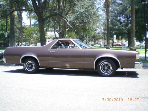 1979 Ford Ranchero - A brown 1979 Ford Ranchero is parked on a street with trees and buildings in the background. The date 7/30/2010 is visible.