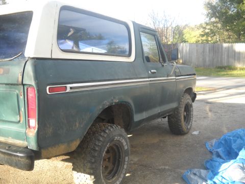 1993 Ford F-150 - This 1978 Ford Bronco is shown from the side, its green paint and white removable top.