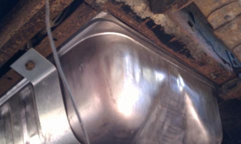 1979 Ford Bronco - Close-up view of a vehicle's fuel tank and frame, showing signs of rust.
