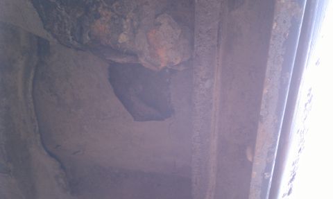 1979 Ford Bronco - Undercarriage detail showing significant rust and corrosion on metal components.
