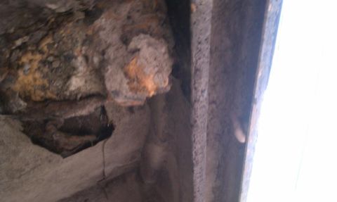1979 Ford Bronco - This image shows significant rust and a hole in what appears to be a metal component, indicating severe deterioration.