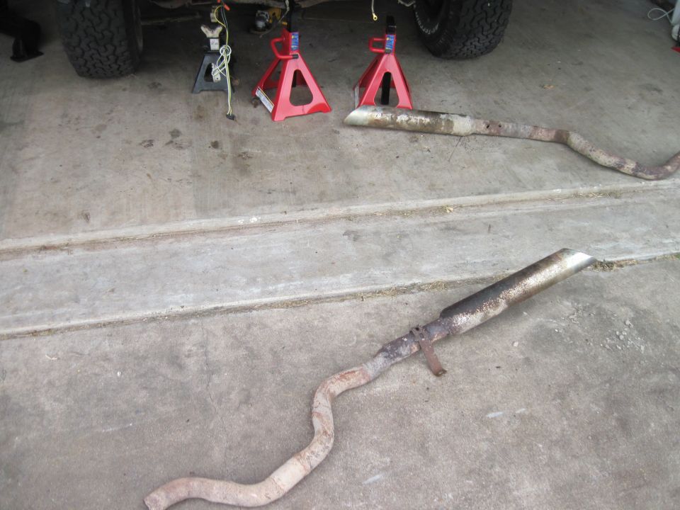 Exhaust pipes removed from vehicle on jack stands
