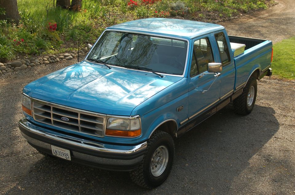 Blue 1992 Ford F-150 pickup truck parked on a gravel driveway