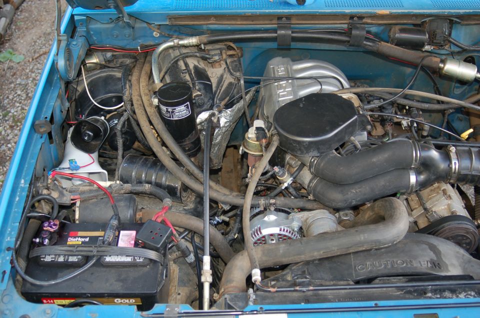 1992 Ford F-150 engine bay with battery and alternator visible