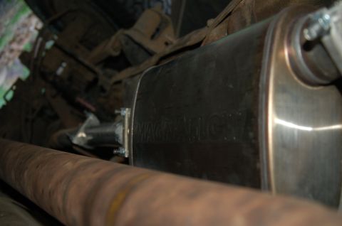 1992 Ford F-150 - Underside view of a vehicle's exhaust system, showing the muffler and driveshaft.