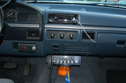 1992 Ford F-150 - The interior of a 1992 Ford F-150 shows a blue dashboard with a CB radio and a modern stereo installed.