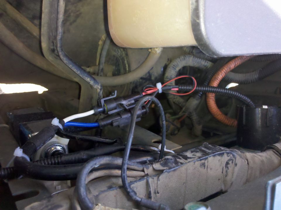 Close-up of vehicle wiring, showing connectors and bundles of wires