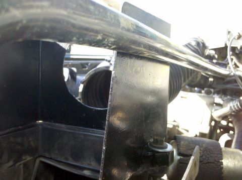 1992 Ford F-150 - Detail of engine bay components, including a black plastic housing and a metal bracket.