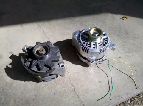 1992 Ford F-150 - Comparison of an older alternator with a newer, polished model, both resting on a concrete surface.