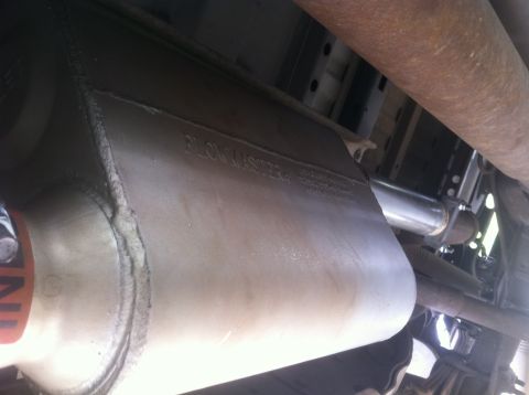 2001 Dodge Dakota - Close-up of a vehicle's exhaust system, showing a Flowmaster muffler and exhaust pipe.