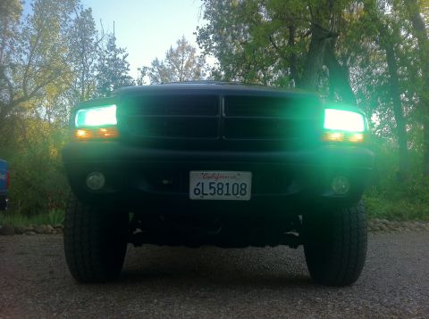 2001 Dodge Dakota - Front view of a black 2001 Dodge Dakota pickup truck, green headlights and a California license plate.
