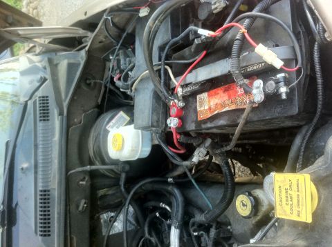2001 Dodge Dakota - Close-up view of a vehicle's engine bay, focusing on the battery and brake fluid reservoir.