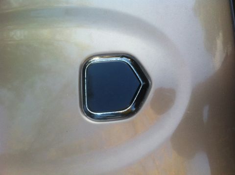 2001 Dodge Dakota - A close-up view of a vehicle's exterior panel, showing a dark, chrome-trimmed insert.