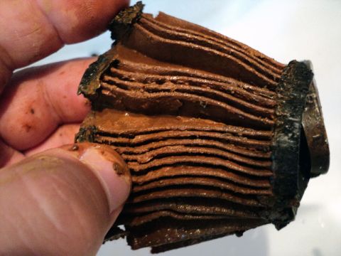 2001 Mercury Grand Marquis - This heavily clogged coolant filter shows significant buildup and contamination.