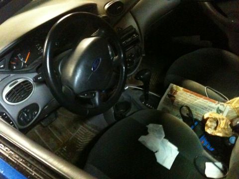 2002 Ford Focus - The interior of a 2002 Ford Focus, showing the steering wheel, dashboard, and center console.