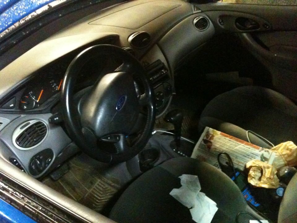 Interior view of a 2002 Ford Focus showing the dashboard, steering wheel, and seats