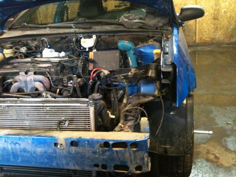 2002 Ford Focus - Front end of a 2002 Ford Focus disassembled, revealing the engine and radiator.
