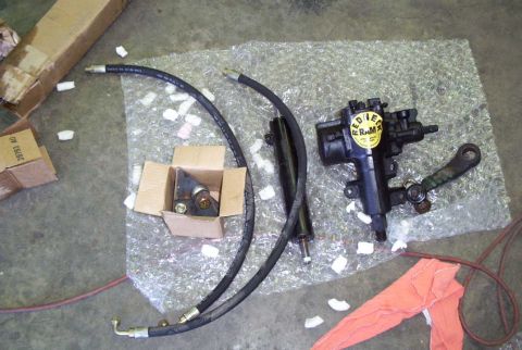 1988 Ford Bronco - Power steering gearbox and hydraulic lines are displayed on a bubble-wrapped surface.