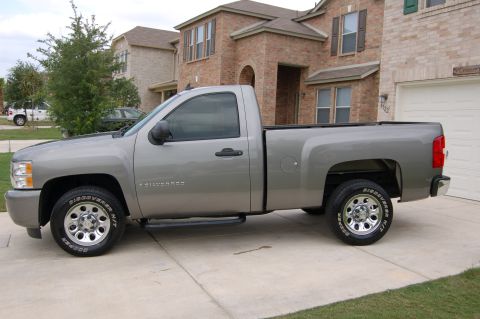 2007 Chevrolet Silverado 1500 - Silver 2007 Chevrolet Silverado 1500 pickup truck parked in front of a brick house.