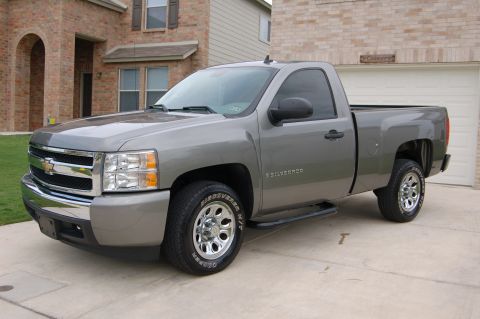 2007 Chevrolet Silverado 1500 - This 2007 Chevrolet Silverado 1500 is parked in front of a brick house with a garage.