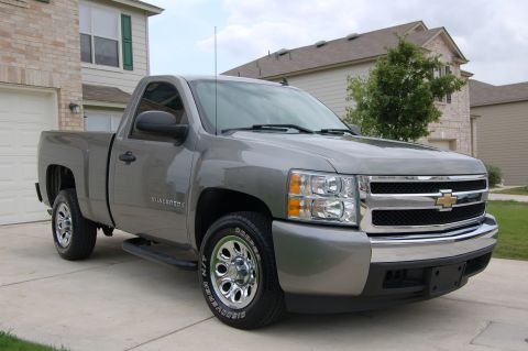 2007 Chevrolet Silverado 1500 - This 2007 Chevrolet Silverado 1500 pickup truck is parked in front of a residential building.