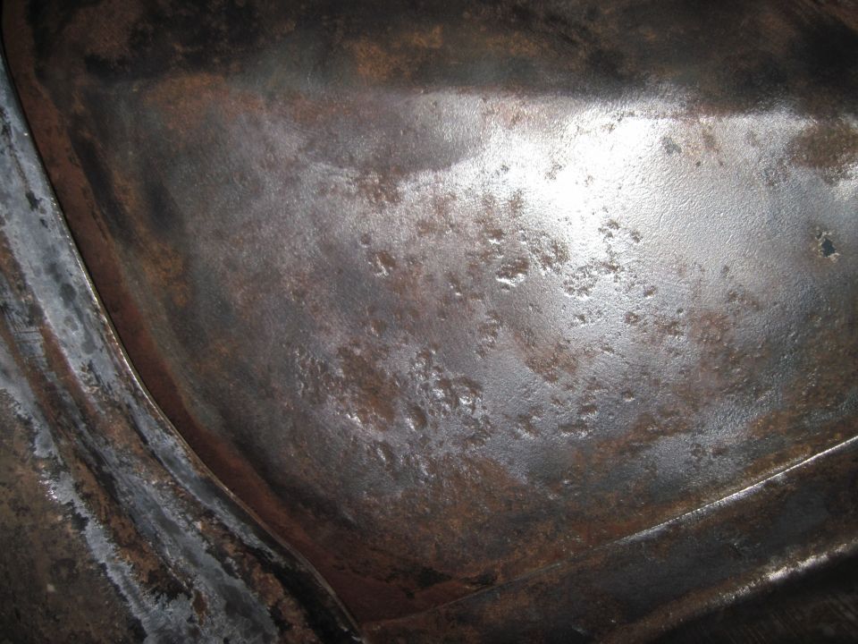 Close-up of heavily rusted metal, possibly from a vehicle undercarriage