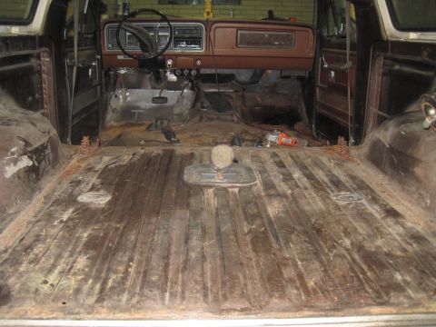 1979 Ford Bronco - The interior of a classic truck is shown, with the dashboard and cargo area visible, indicating a need for restoration.