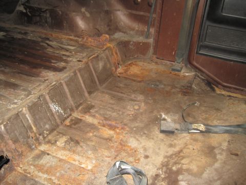 1979 Ford Bronco - The interior floor of the vehicle shows significant rust and wear.