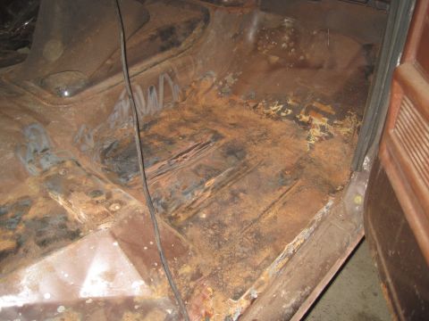 1979 Ford Bronco - Interior floor pan shows significant rust and damage, indicating a need for restoration.