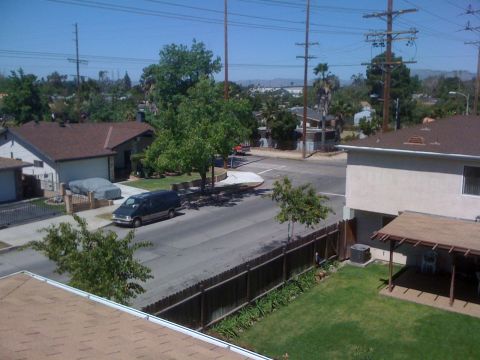 1968 Ford Mustang - A dark blue van is parked on the side of a street in a suburban neighborhood.